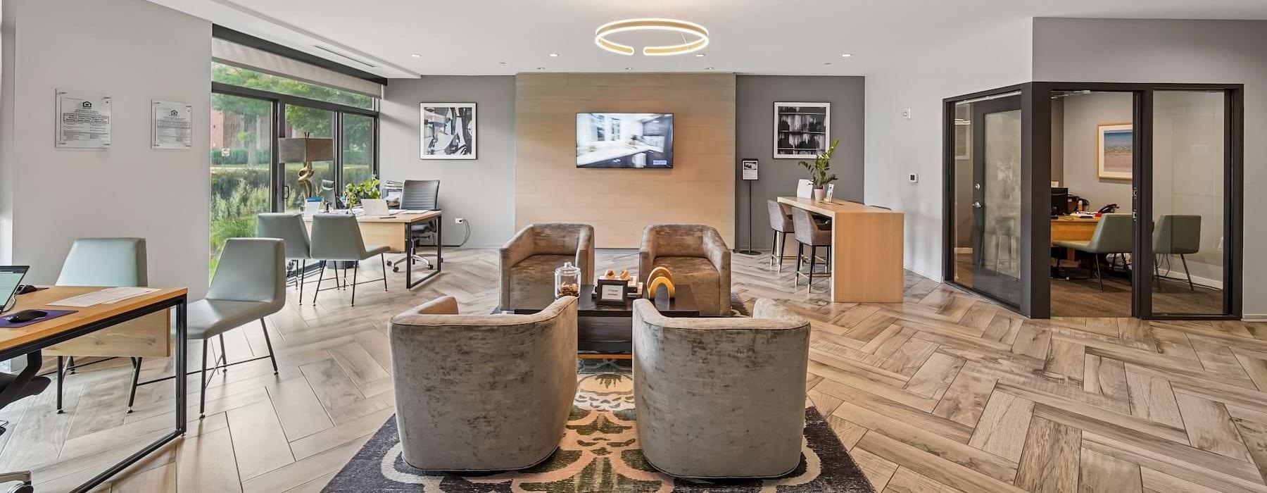 a room with a large rug and chairs
