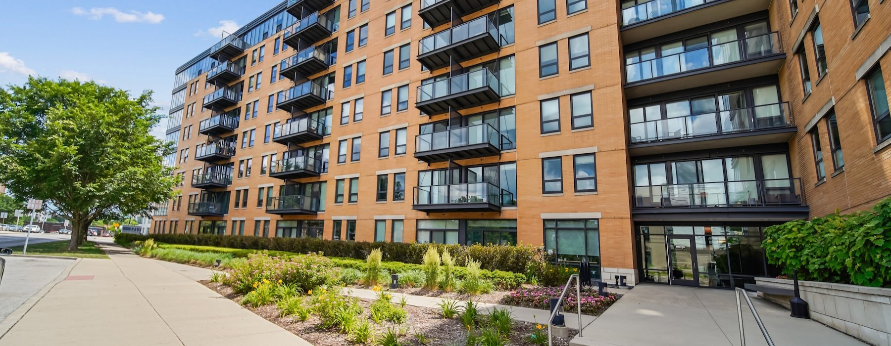 a building with balconies and a sidewalk